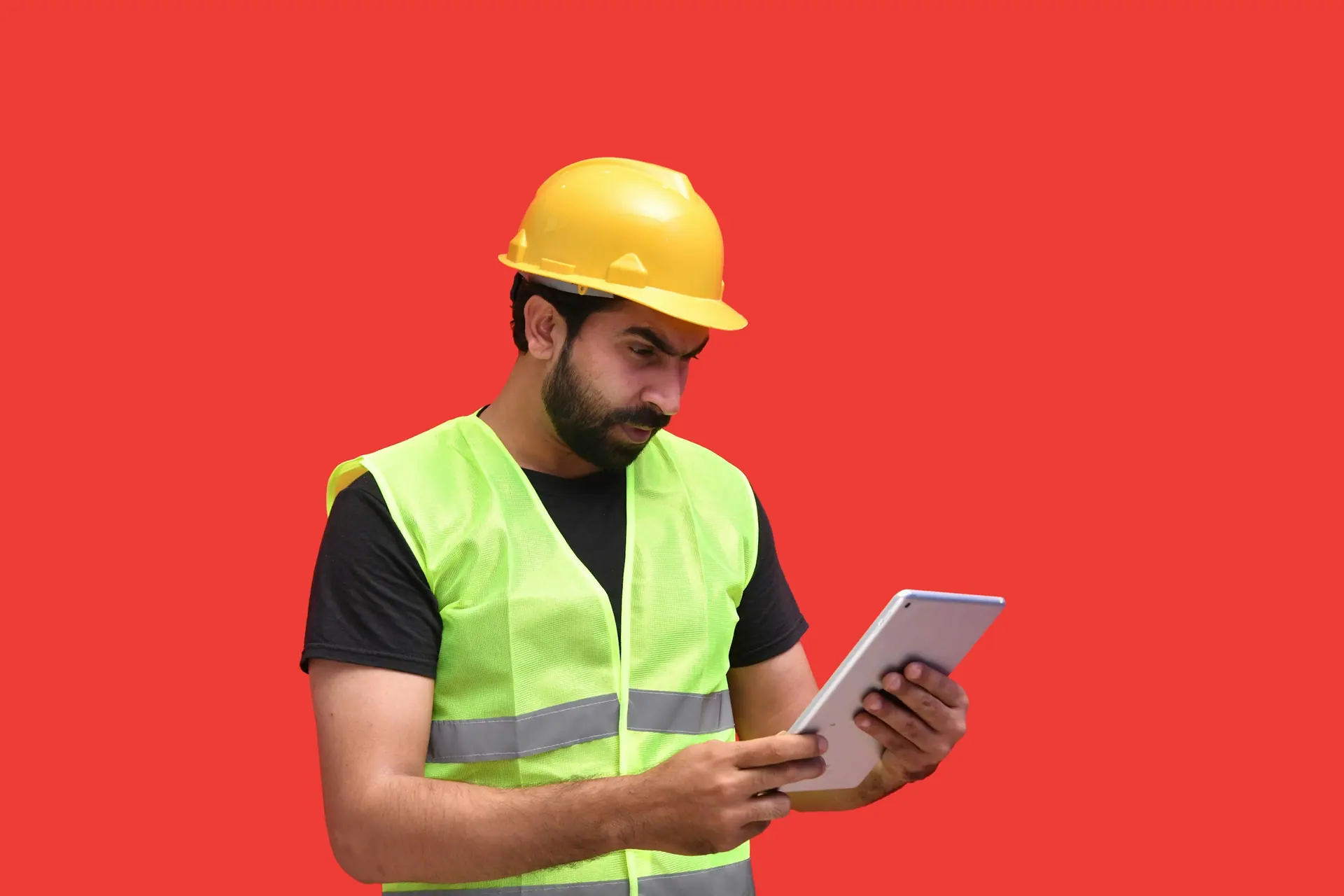 Worker reviewing information on a tablet on a construction site